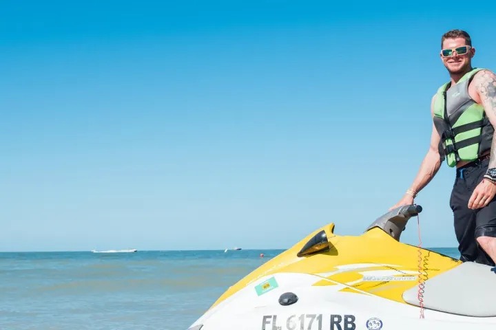 a man standing on a boat in the water