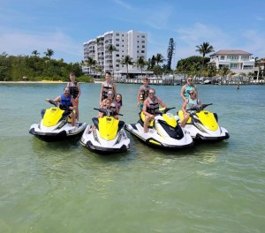 a group of people riding on the back of a boat