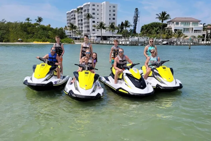 a group of people riding on the back of a boat