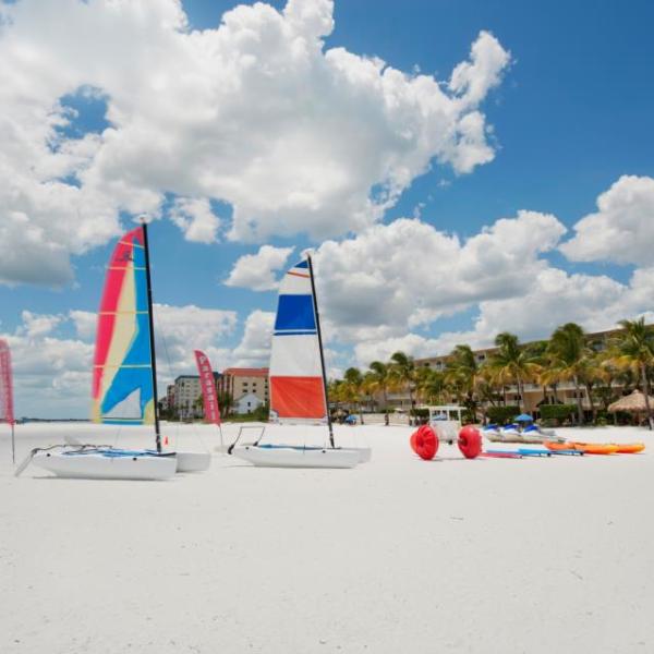 a sailboat sitting on top of a sandy beach