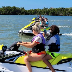 a person sitting on a waverunner in a body of water