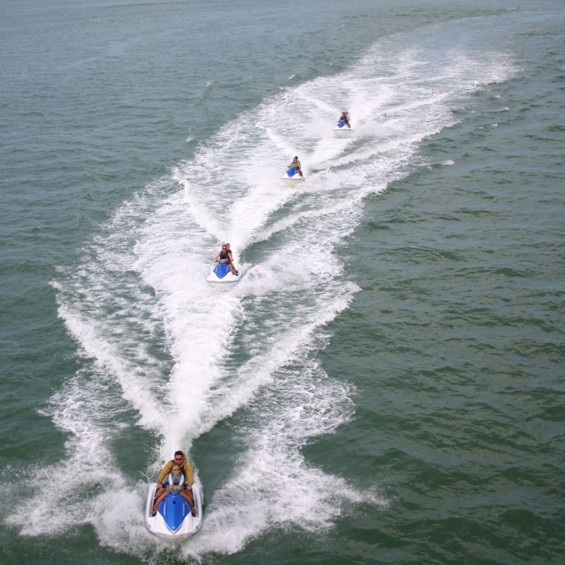 a line of waverunners in the water