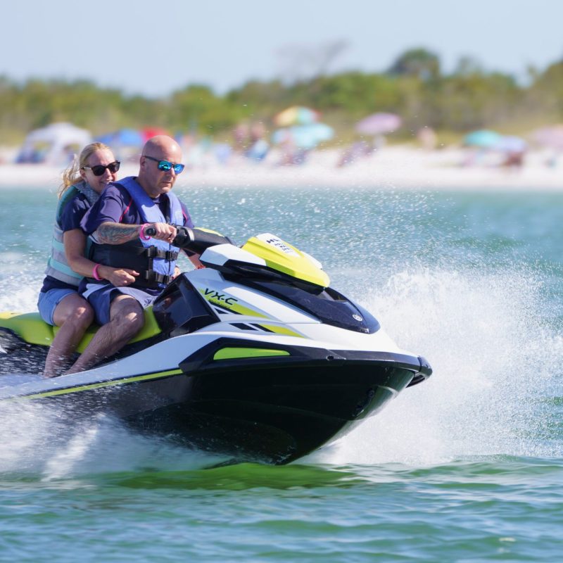 a couple riding a jetski