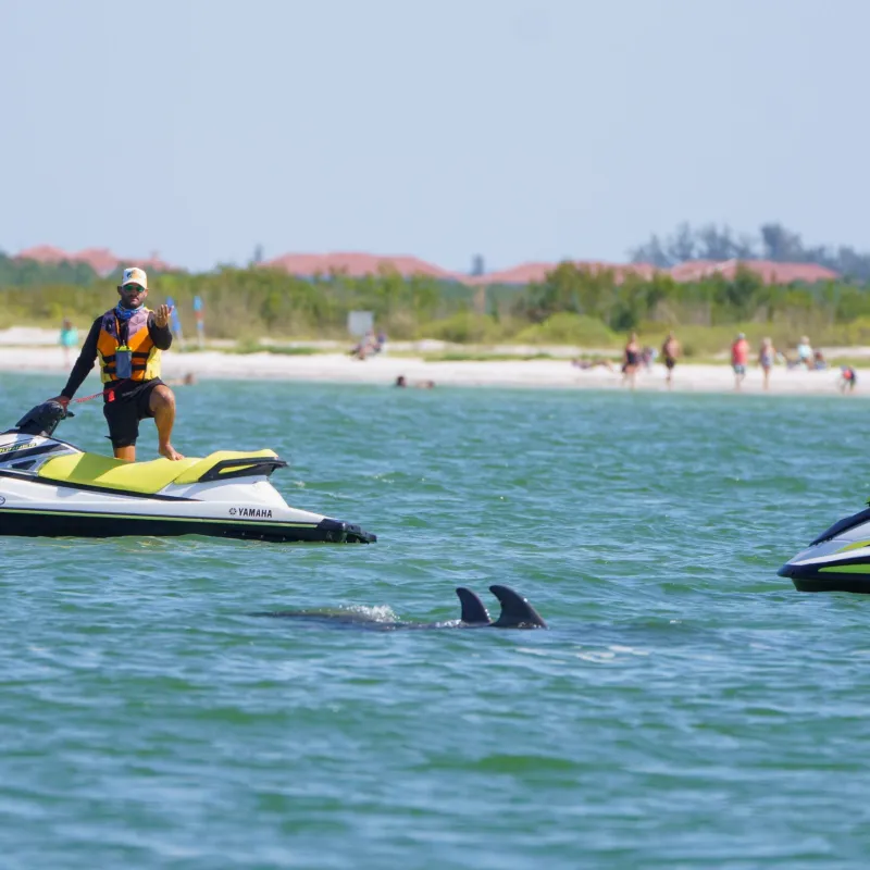 a group of people riding on the back of a jetski in the water