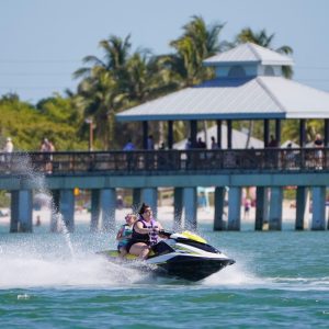 a person riding on the back of a boat in the water