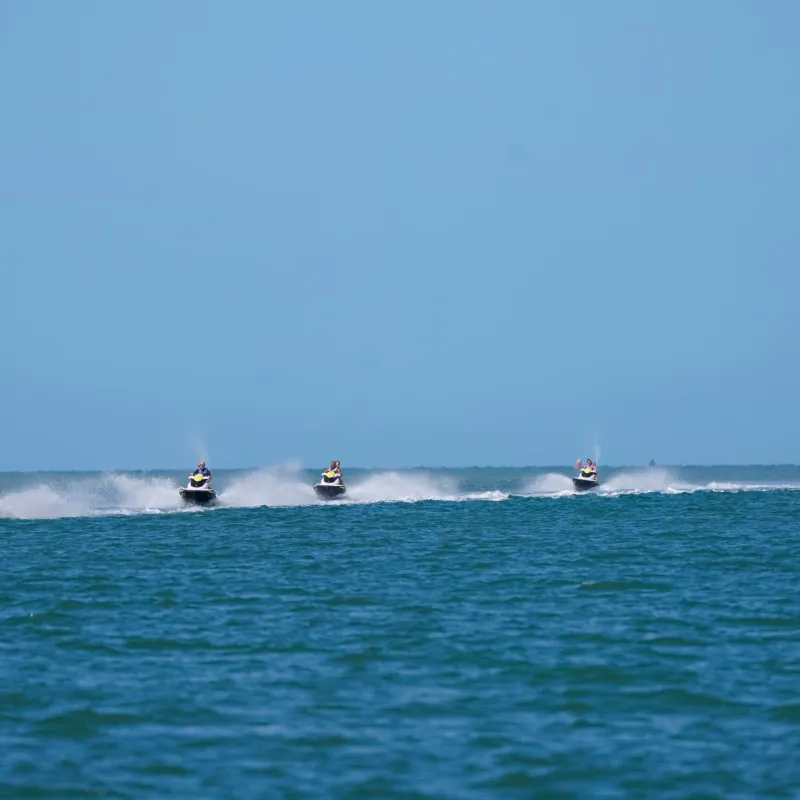 a group of people riding jetskis on a body of water