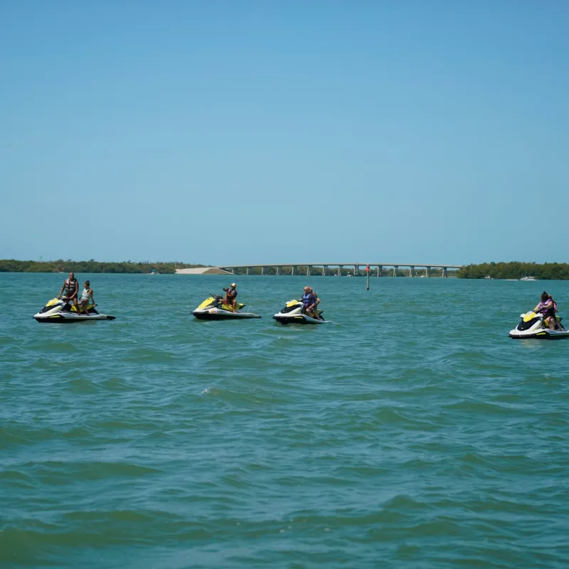a group of people on jetskis in a body of water