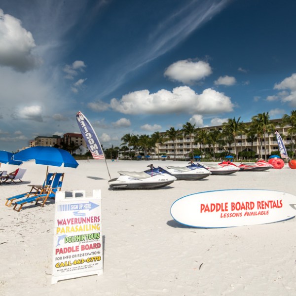 a boat sitting on top of a sandy beach