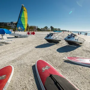 a boat sitting on top of a sandy beach