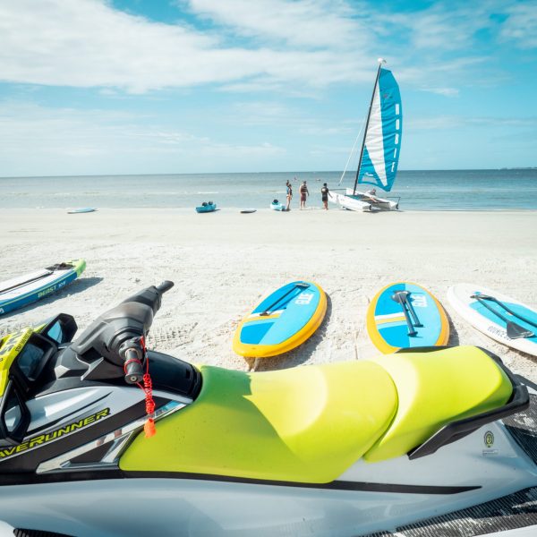 a jetski and paddle boards on the beach