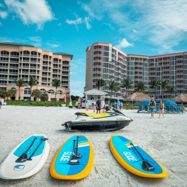 a beach with paddle boards