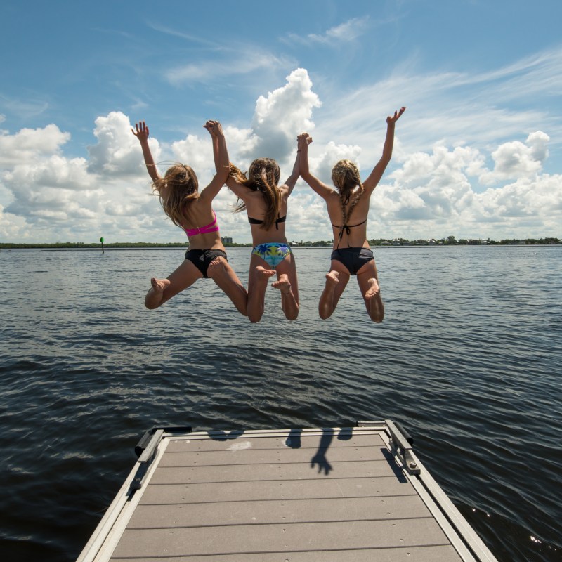 a group of people jumping into the water
