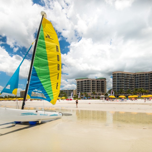 a boat sitting on top of a sandy beach